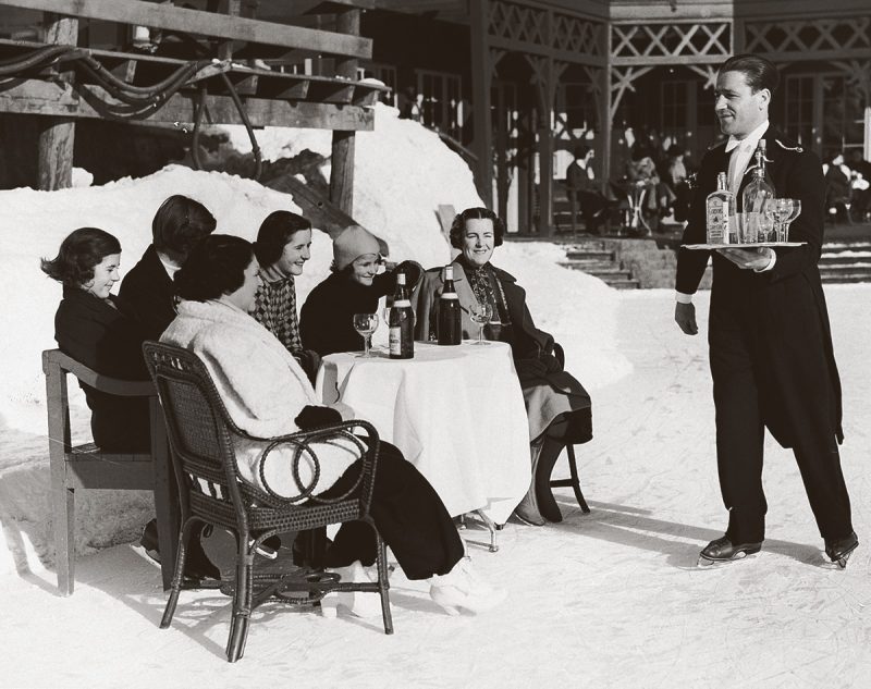 An-ice-skating-waiter-in-St.-Moritz-Switzerland-delivers-gin-and-soda-to-British-ladies-1920s-Hulton-Deutsch-Collection-CORBIS-Corbis-via-Getty-Images